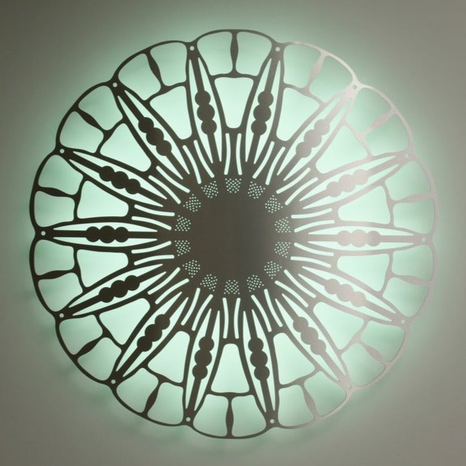 KuvaLight Anemoon in brushed aluminium with a peppermint green color light during the day.