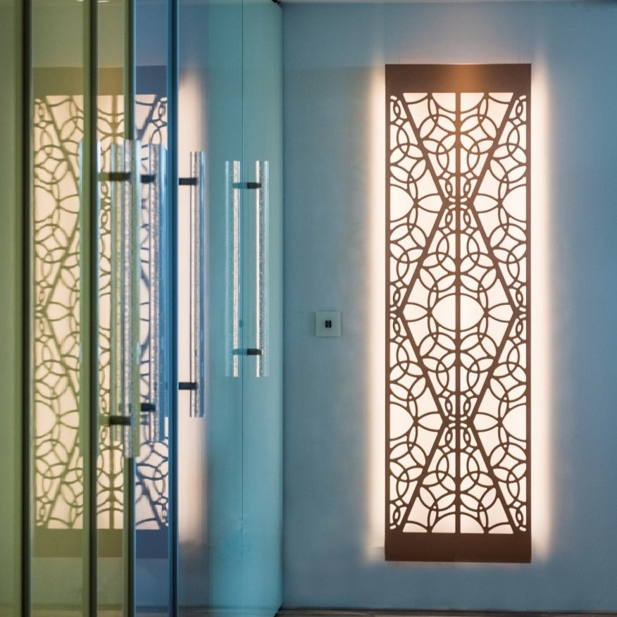 KuvaLight Minho 2 in brushed copper with warm white light hanging vertically in a hallway.