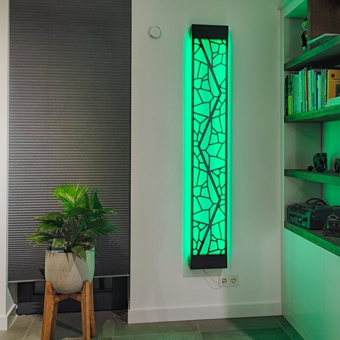 KuvaLight Mosaic design lamp in Piano Black with a green light in a evening home setting.