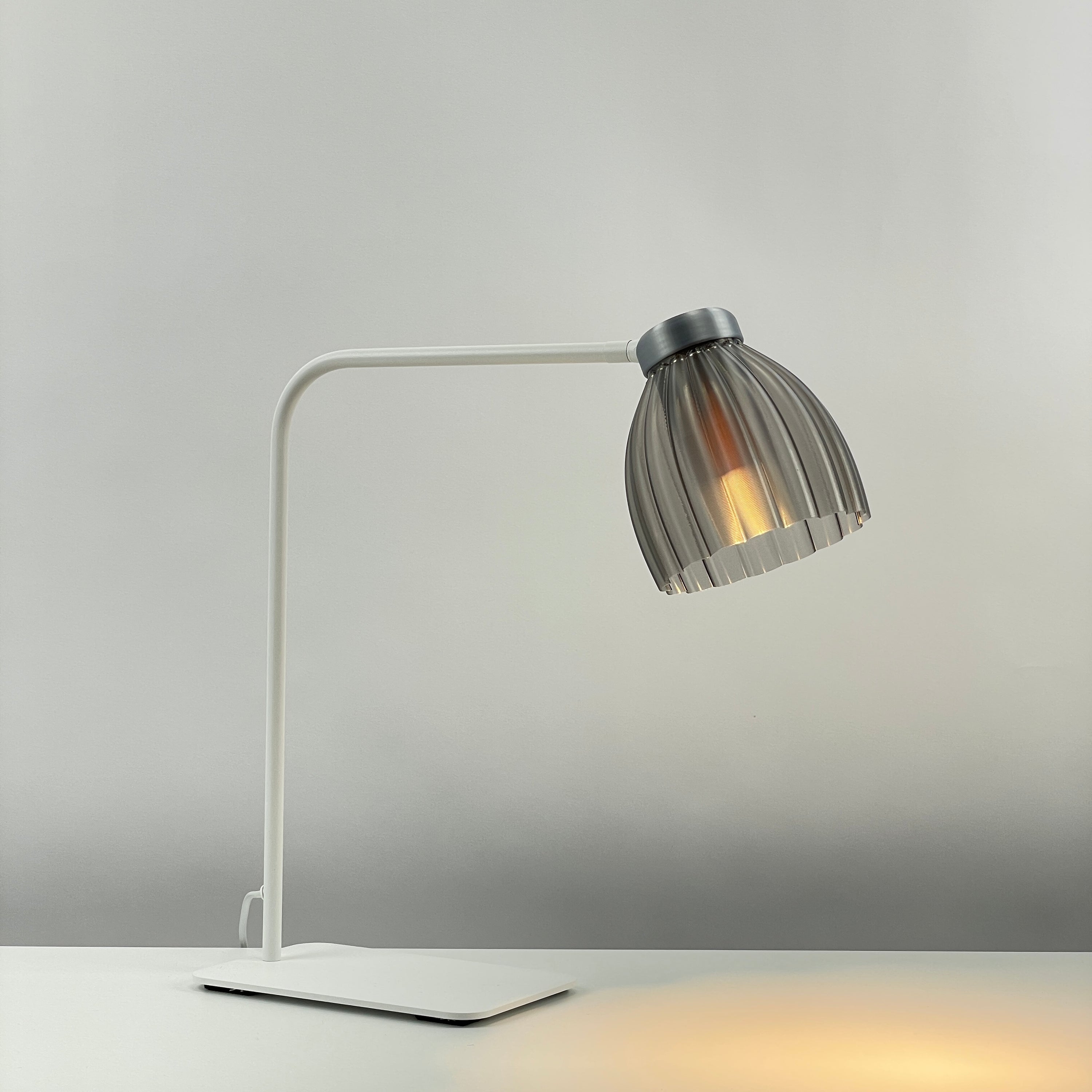 Blossom_white_table_desk_light – smoked colored transparent_grey-metallic_diffuser_on 
