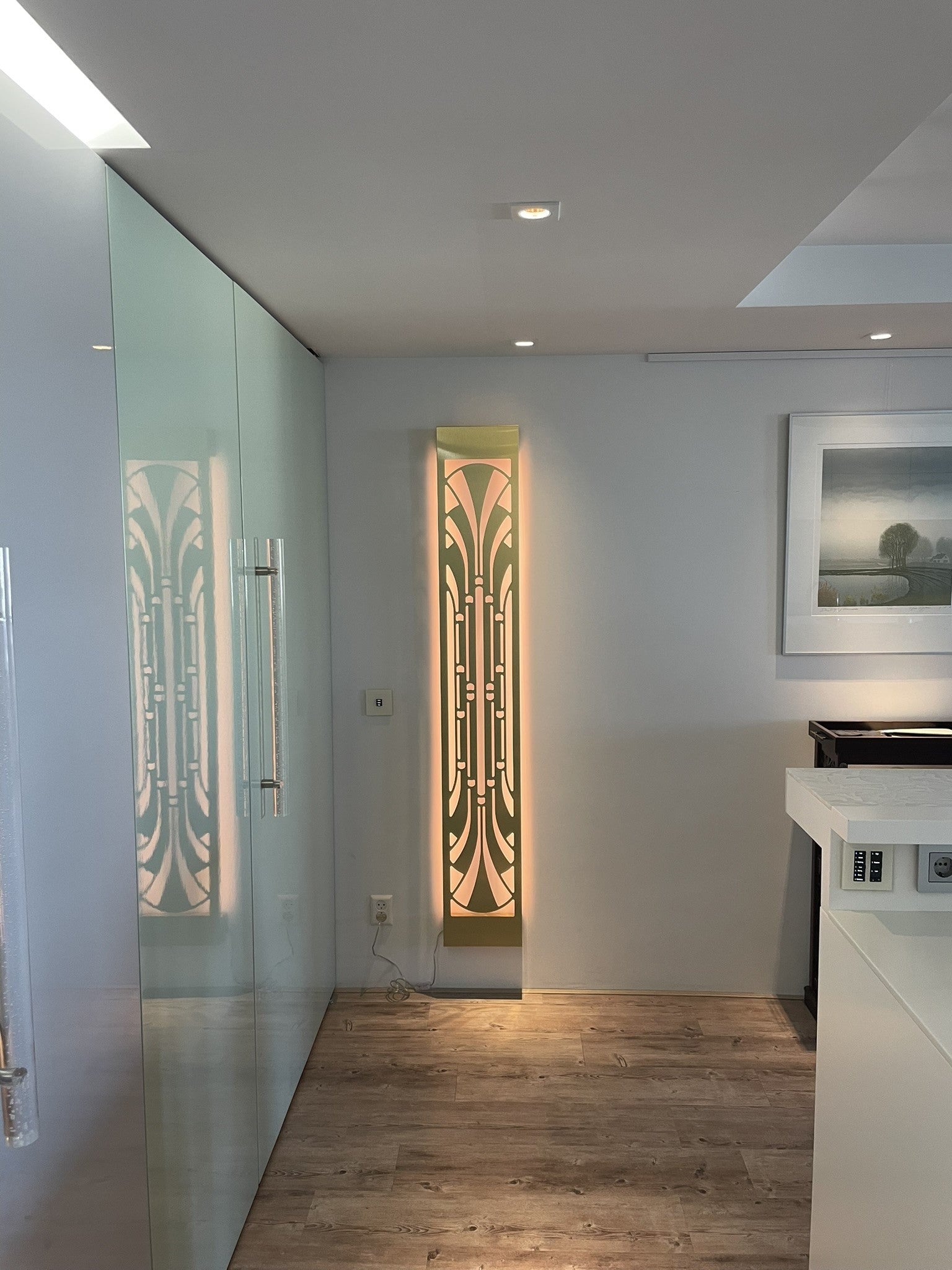 KuvaLight Art Deco Miami Slim wall light in brushed finish, vertically mounted at the end of a hallway with warm light on.