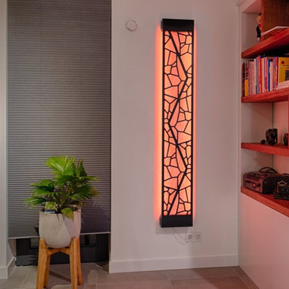 KuvaLight Mosaic design lamp in Piano Black with a orange light in a evening home setting.