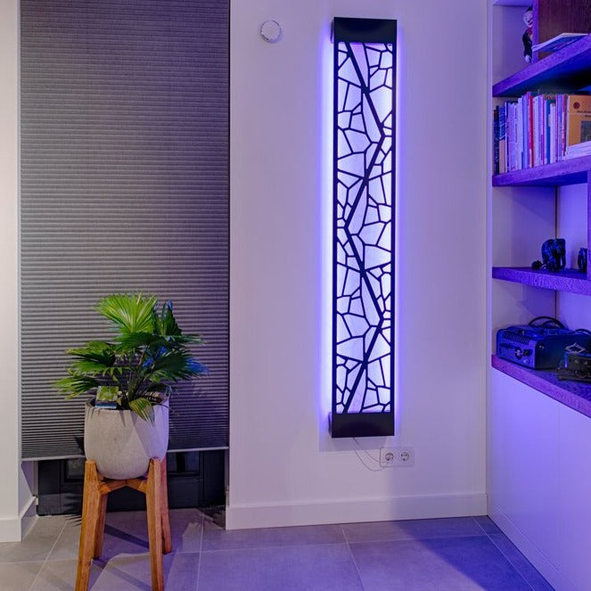 KuvaLight Mosaic design lamp in Piano Black with a blue light in a evening home setting.