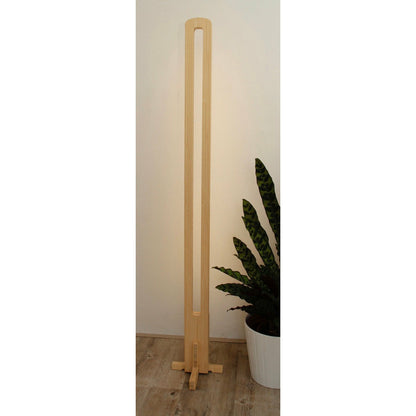 KuvaLight Parallel in Bamboo with a white light standing in front of a wall.
